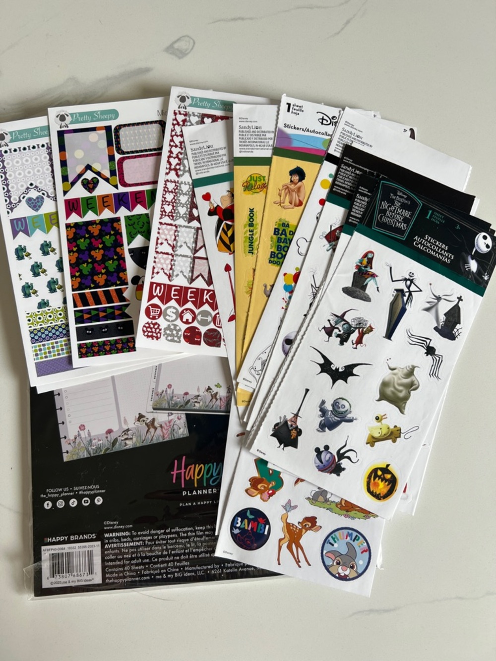 Assorted Disney stickers and Happy Planner Bambi organizer